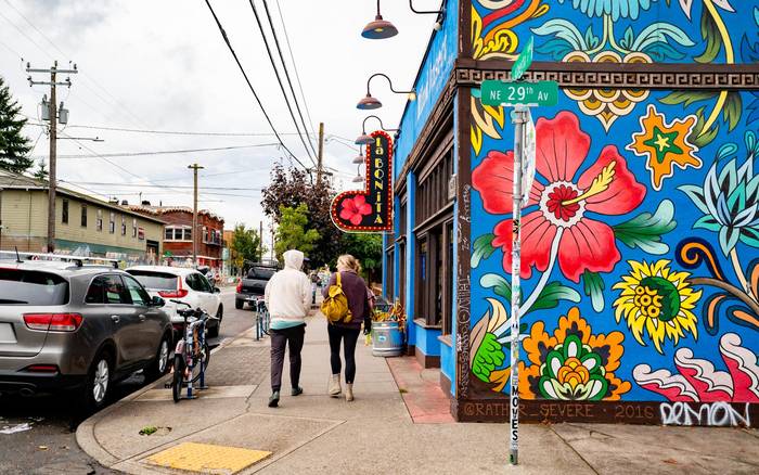 A painted floral mural on a corner building on NE Alberta Street