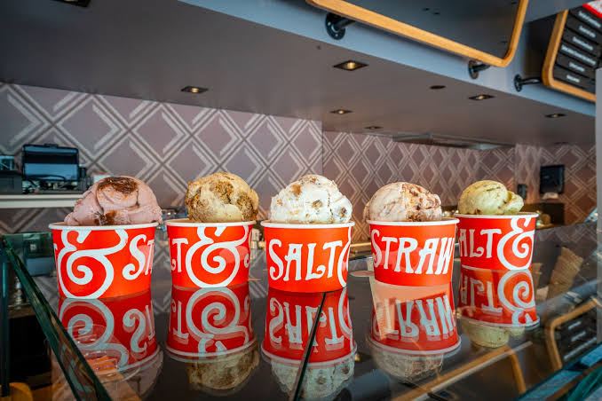 A row of Salt and Straw ice cream cups on a counter