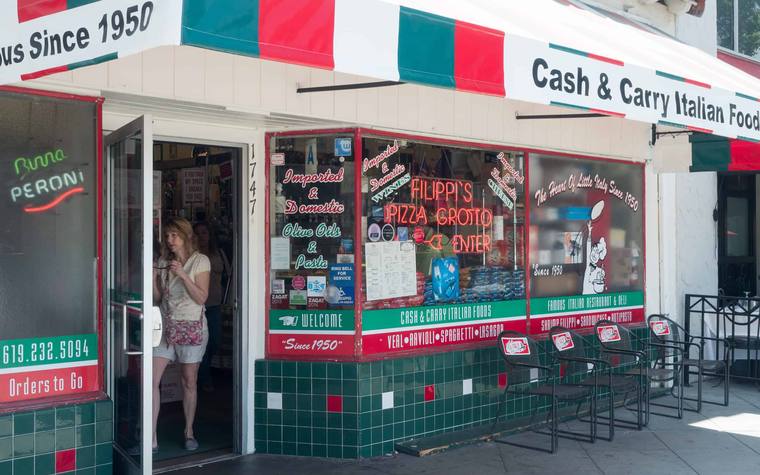 The green-tiled storefront of Filippi's Pizza Grotto on India Street