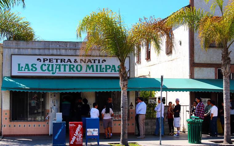 The queue outside Las Cuatro Milpas under its green awnings