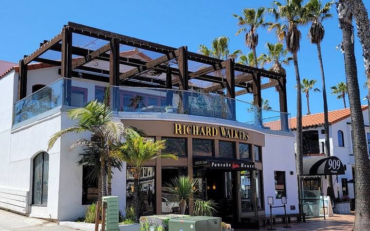 The Richard Walker's Pancake House building with palms and a roof terrace
